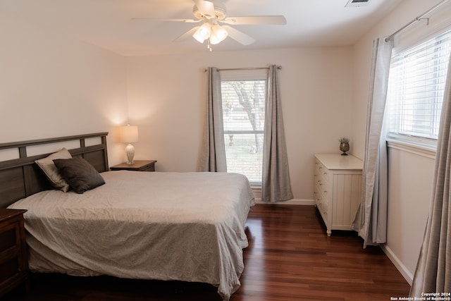 bedroom with ceiling fan and dark hardwood / wood-style flooring