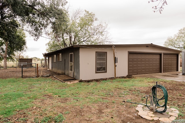 view of front of property with a garage and an outbuilding