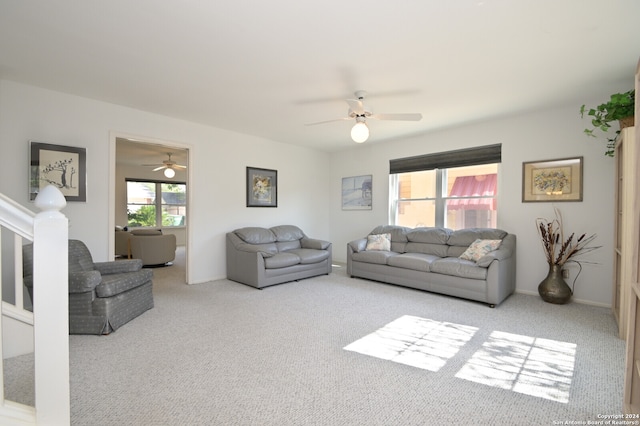 living room featuring a wealth of natural light, ceiling fan, and light carpet