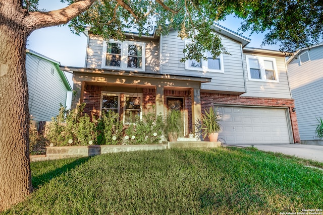 view of front of property with a front yard and a garage