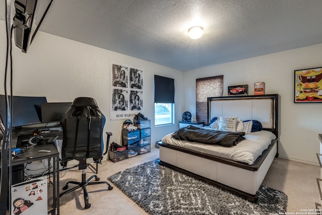 bedroom featuring light colored carpet and a textured ceiling