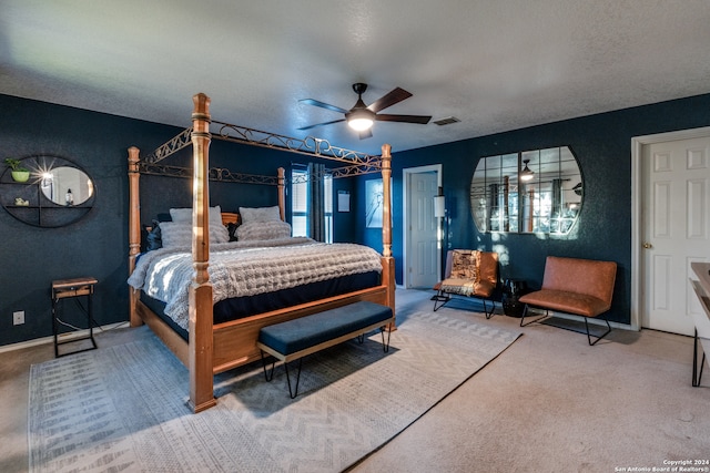 bedroom featuring ceiling fan, carpet floors, and a textured ceiling