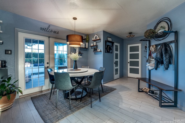 dining room with french doors and a textured ceiling