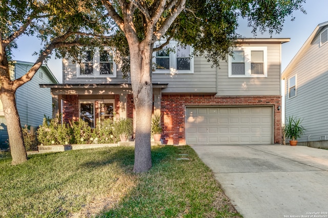 view of front of house featuring a front yard and a garage