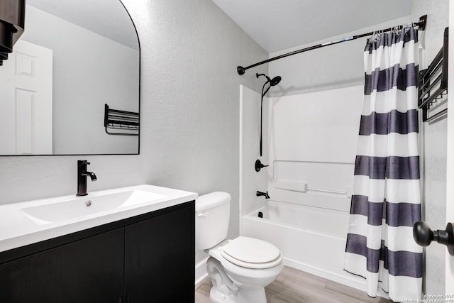 full bathroom featuring vanity, wood-type flooring, shower / tub combo, and toilet