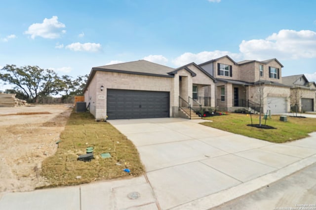 5728 Sendero Rnch, San Antonio, TX 78253 - view of front facade featuring a garage, driveway, central air condition unit, and a front lawn