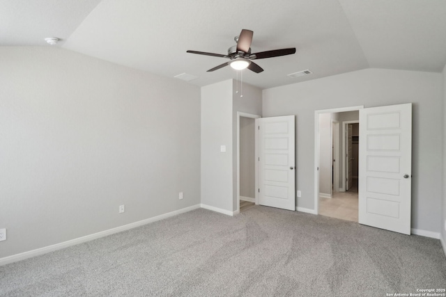 unfurnished bedroom featuring lofted ceiling, baseboards, visible vents, and carpet floors