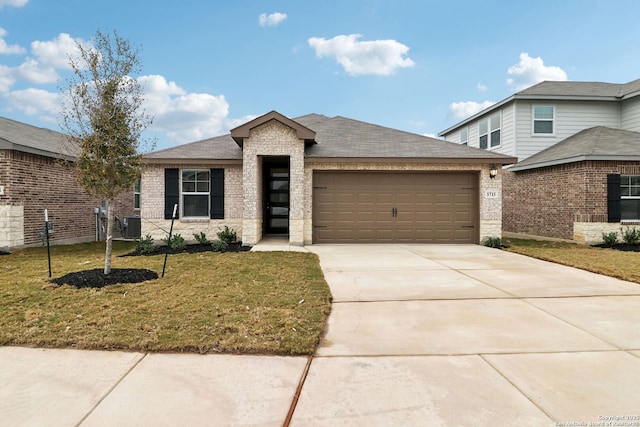 5715 Sendero Rnch, San Antonio, TX 78253 - view of front of house with an attached garage, a front yard, driveway, central AC, and brick siding