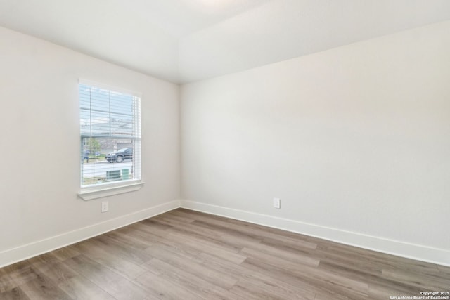 spare room with light hardwood / wood-style flooring