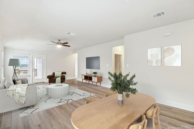 living room featuring ceiling fan and light hardwood / wood-style flooring