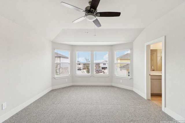 unfurnished room with vaulted ceiling, light colored carpet, and ceiling fan