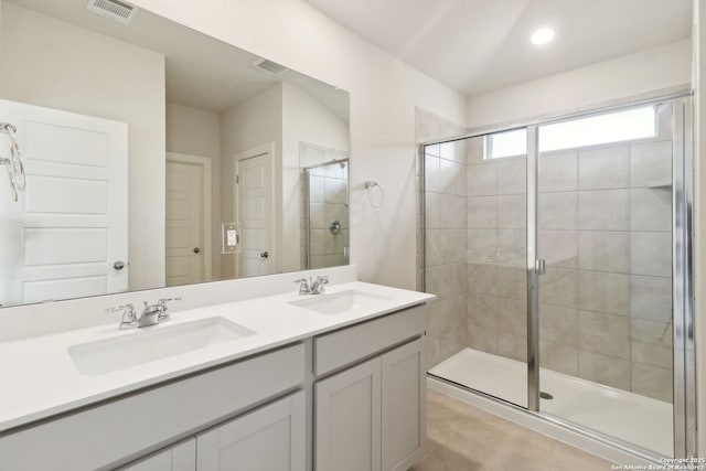 bathroom with vanity and a shower with shower door