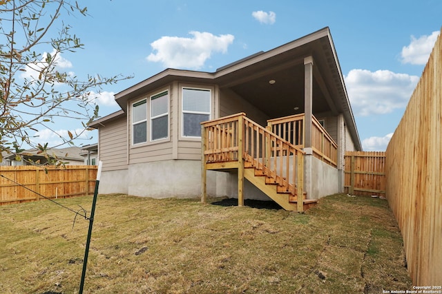 rear view of property with a lawn