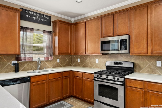 kitchen featuring sink, decorative backsplash, light tile patterned floors, ornamental molding, and stainless steel appliances