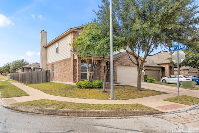 view of front of house featuring a front yard and a garage