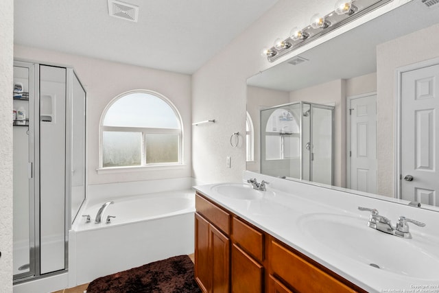 bathroom featuring vanity, a textured ceiling, and plus walk in shower