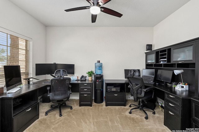 home office featuring ceiling fan and light colored carpet