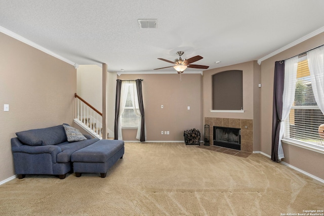 living room featuring ornamental molding, a fireplace, and a wealth of natural light