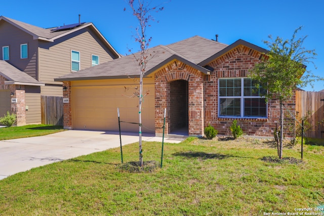 view of front of home with a garage and a front lawn