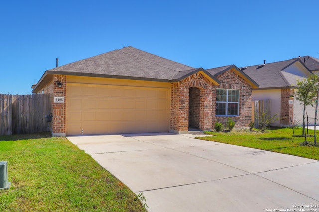 ranch-style home with a garage and a front yard