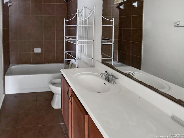 full bathroom featuring tile patterned flooring, vanity, tiled shower / bath combo, and toilet