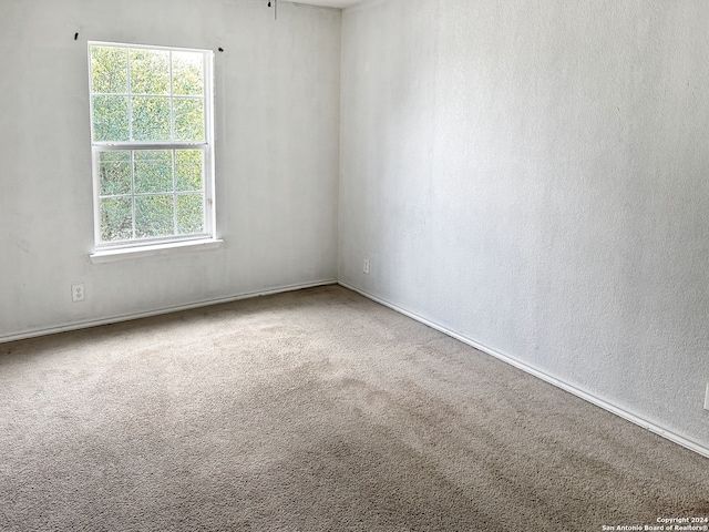 carpeted spare room with a healthy amount of sunlight