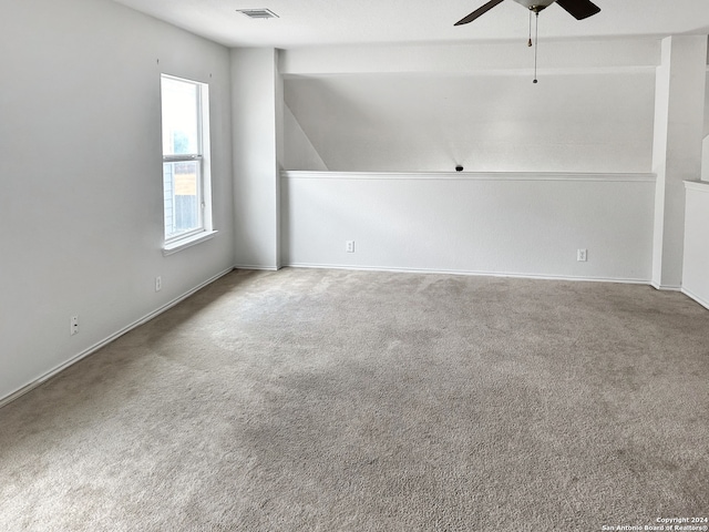 spare room with carpet, ceiling fan, and lofted ceiling