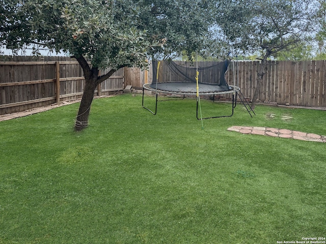 view of yard with a trampoline