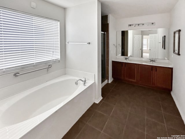 bathroom with tile patterned flooring, vanity, and shower with separate bathtub