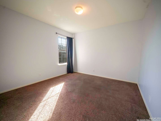 empty room with dark carpet