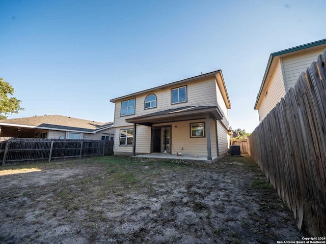 rear view of property featuring a patio and central air condition unit