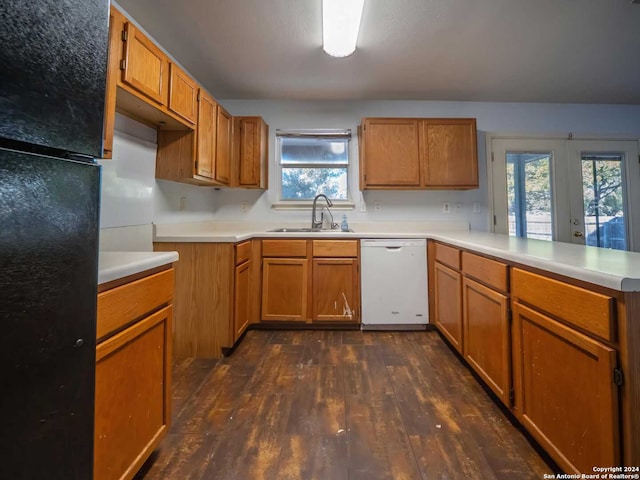 kitchen with sink, french doors, dark wood-type flooring, kitchen peninsula, and white dishwasher