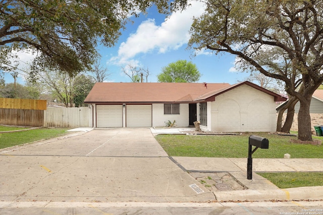 single story home with a garage and a front yard