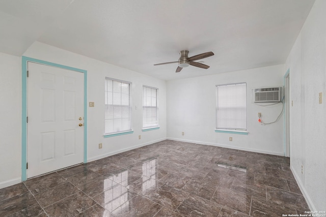 entrance foyer featuring an AC wall unit and ceiling fan