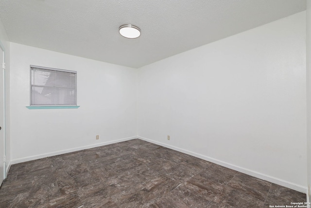 empty room featuring a textured ceiling