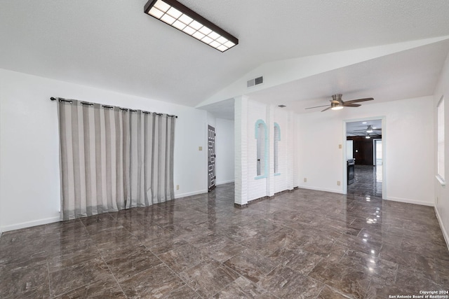 unfurnished living room with a textured ceiling, ceiling fan, and lofted ceiling