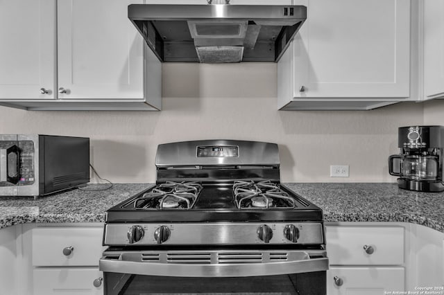 kitchen with white cabinets, stainless steel appliances, light stone counters, and exhaust hood