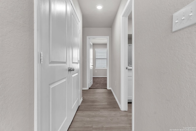 hall with light hardwood / wood-style flooring