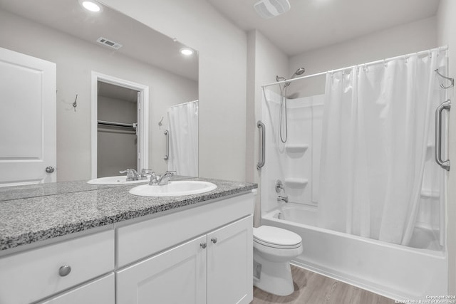 full bathroom with vanity, wood-type flooring, shower / tub combo, and toilet