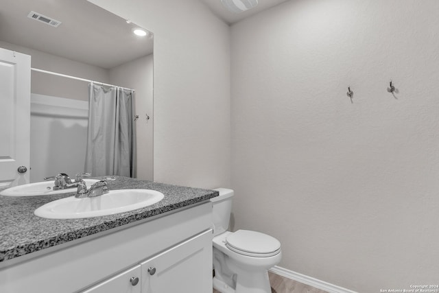 bathroom with a shower with curtain, vanity, toilet, and wood-type flooring