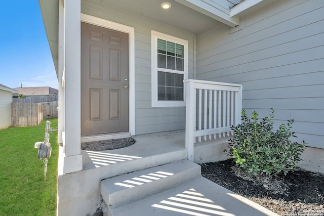 view of exterior entry featuring covered porch