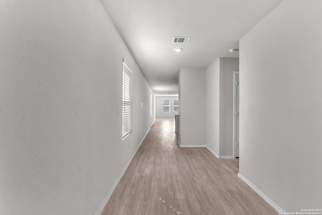 hall with light hardwood / wood-style floors