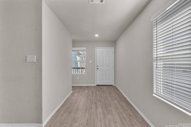 corridor with light hardwood / wood-style flooring