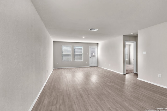 unfurnished room with hardwood / wood-style flooring