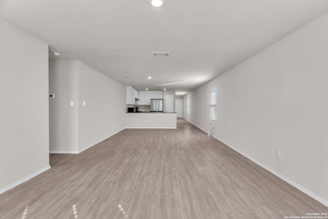 unfurnished living room featuring light hardwood / wood-style floors