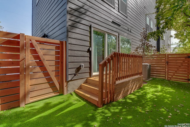 wooden deck with a lawn and cooling unit