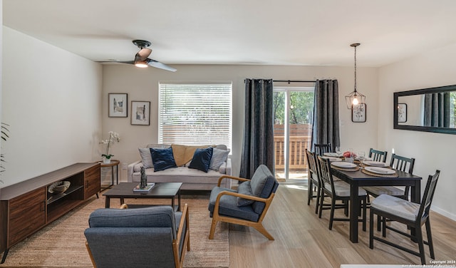 living room featuring ceiling fan and light hardwood / wood-style floors