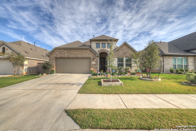 view of front of property with a garage and a front lawn