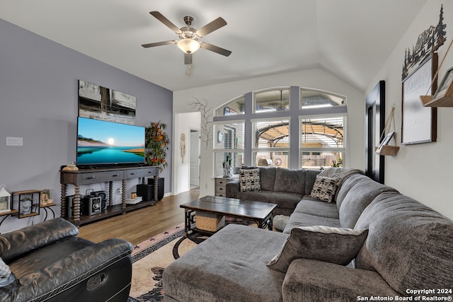 living room with hardwood / wood-style floors, ceiling fan, and lofted ceiling