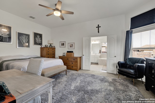 bedroom featuring carpet, ensuite bath, and ceiling fan